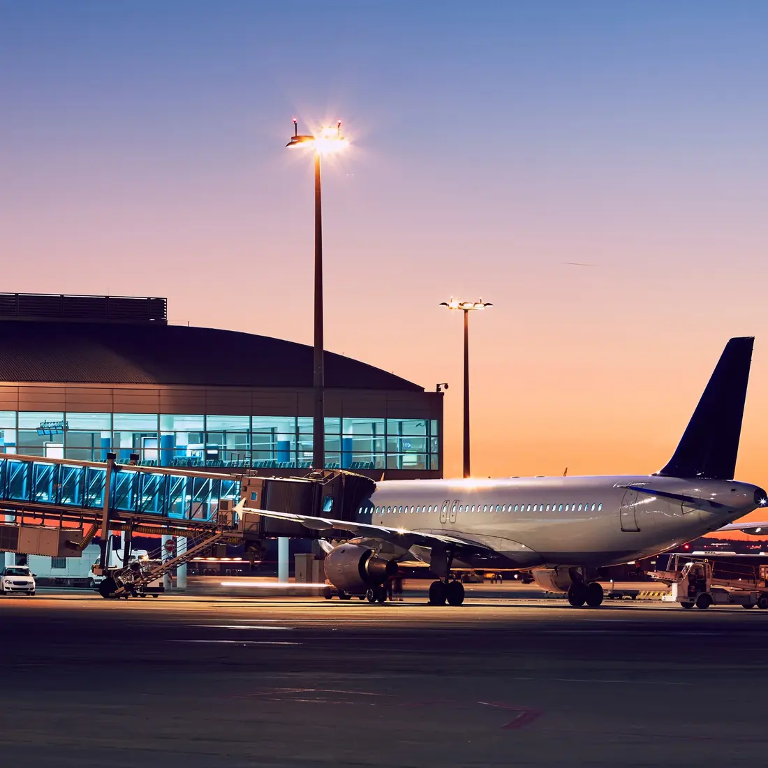 Aircraft at the airport gate at sunset